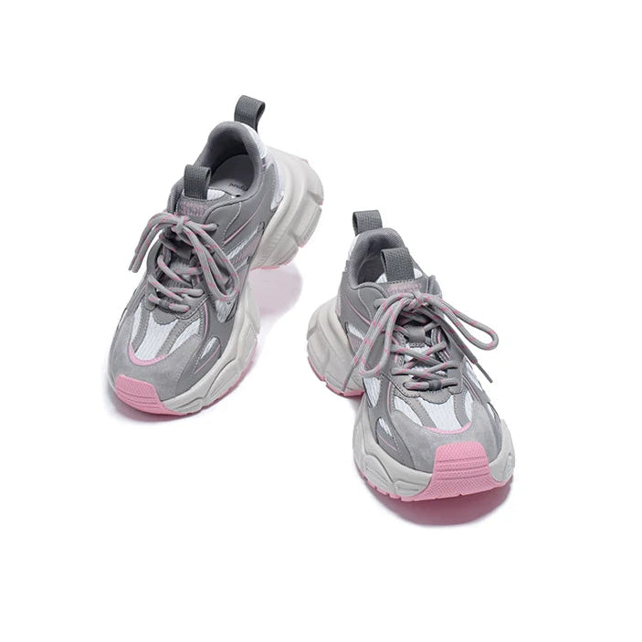 Gray and pink sneakers on a white background
