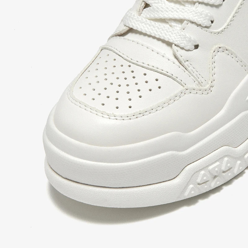 Close-up of a white sneaker with a focus on the sole and side profile.