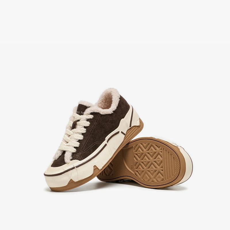 Brown sneakers with white laces and light brown soles on a white background