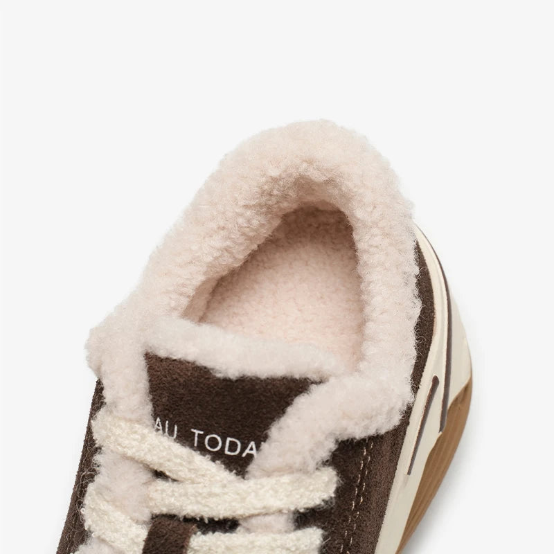 Close-up of a brown shoe with white fur lining on a white background