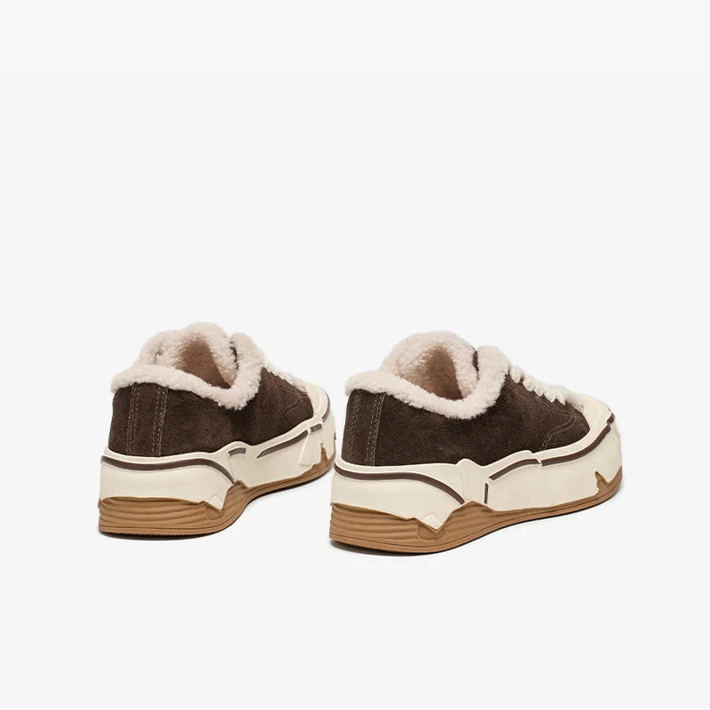 Pair of brown sneakers with white soles and fur lining on a white background