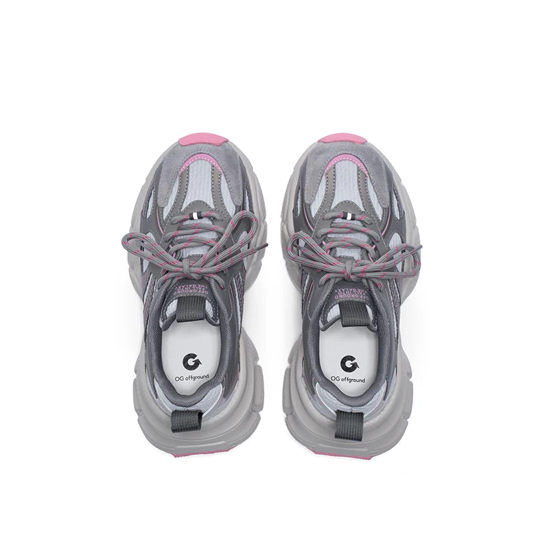 Pair of gray sneakers with pink accents on a white background